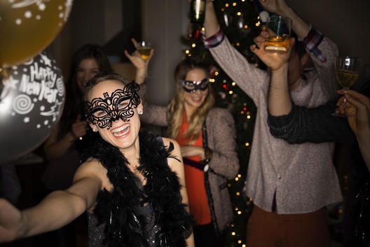 Woman in maquerade mask enjoying New Years Eve party