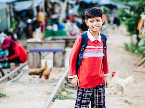 A student stands along the abandoned railroad tracks next to Empowering Youth in Cambodia's Lakeside School in an impoverished neighborhood of Phnom Penh, Cambodia.