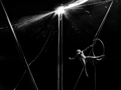 A trapeze artist works through her routine in a traveling one tent family circus.