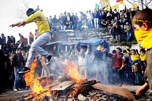 Man Jumping Over A Bonfire During The Spring Celebration Newroz, Istanbul, Turkey.
