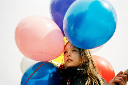 Portrait Of A Girl Holding Balloons And Looking Sad On Her Birthday, Montreal, Quebec, Canada.