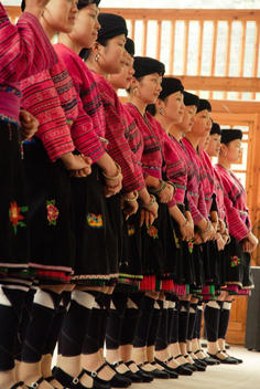 Group Profile Of Miao (Ethnic Group) Women In Traditional Colorful Clothes And Earrings Smiling. Women In This Area Have Long Hair Gathered In A Knot On The Top Of The Head. About To Perform A Traditional Dance For Tourists