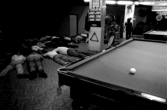 Moscow, Russia 1995 ROUP, the department Against Organized Crime in Moscow, busts a pool hall to break a rasbourka in process. Eveyone is immeddiately forced to the floor by ROUP. Guns are found and arrests made.