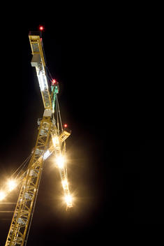 Yellow Construction Cranes At Night