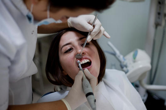 Dental patient is getting her teeth fixed in a dentist office in Istanbul.