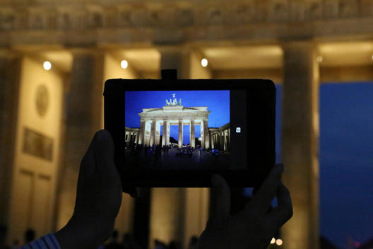 Taking a picture of the Brandenburg Gate at night, Berlin