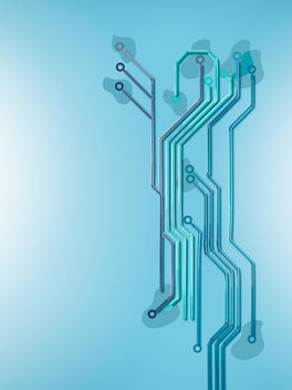 Assortment of blue toned straws making a computer chip design on blue