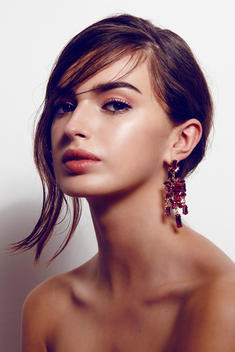 editorial beauty shoot with natural skin and pink earring