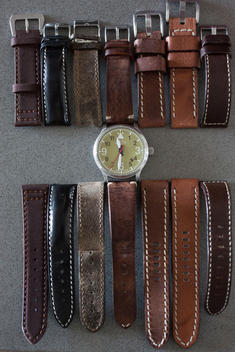 a watch arranged with various different leather and nylon straps