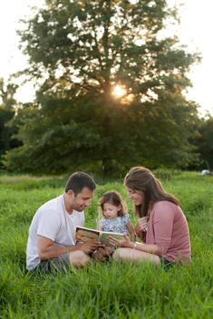 family reading outside