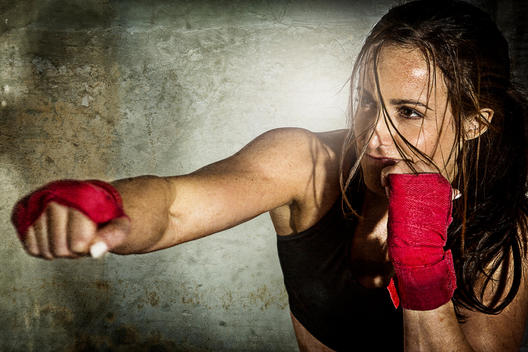 Woman exercising with punching bag
