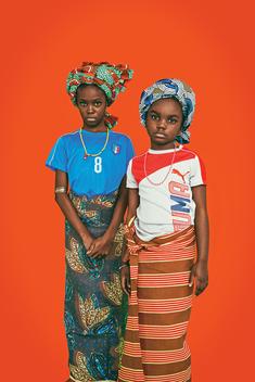 kids fashion shoot in studio with colorful background mixing european football jerseys with traditional african clothes and textiles