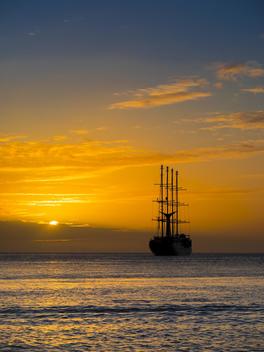 Caribbean, St. Lucia, Sailing cruise ship Wind Star at sunset