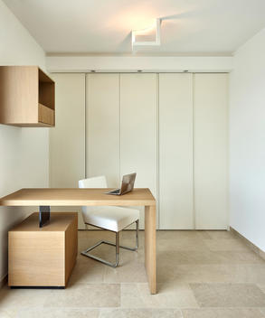 White House, L'Ametlla. Modern work space with streamlined desk and white chair, minimal decoration.