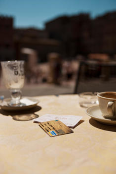 Credit card and bill on an exterior restaurant or cafe table
