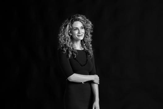 Emotional and Empowering Black and White Studio Portrait of Curly Haired Woman