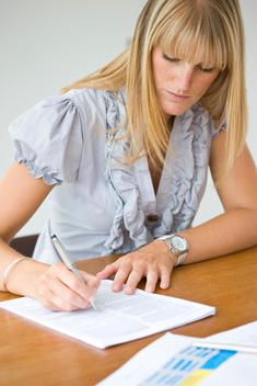 Businesswoman Signing Paperwork