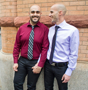 Two men holding hands waiting to get married at City Hall, NYC