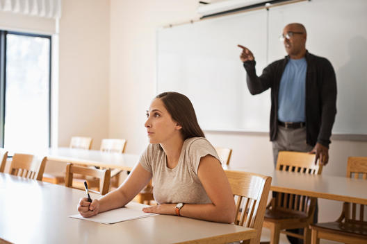 Professor and student talking in classroom