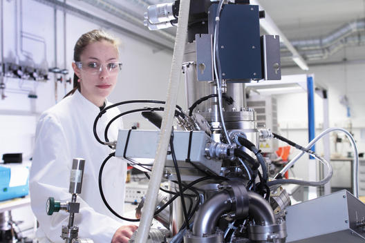Portrait of female lab technician with scientific equipment