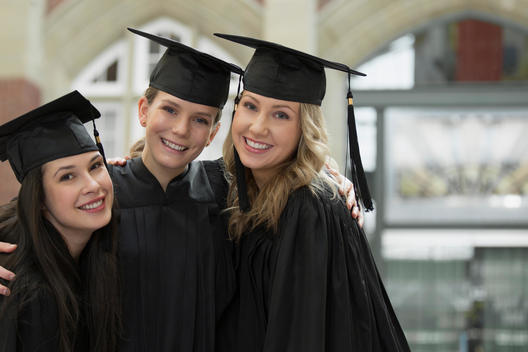 Portrait of happy college graduates