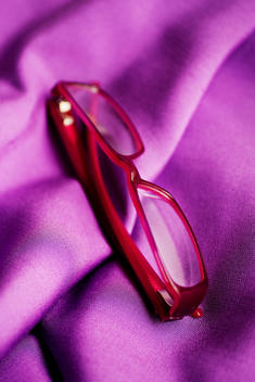 Red spectacles on purple cloth