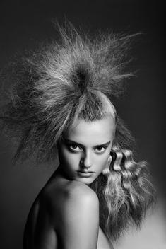 hair beauty image of a caucasian female in her early twenties showing a modern frizzy hair do