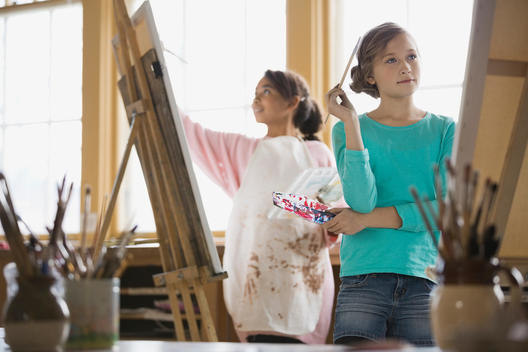 Girls painting in art class