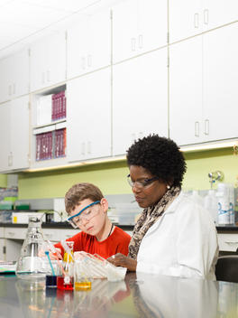 Student and teacher working in chemistry lab