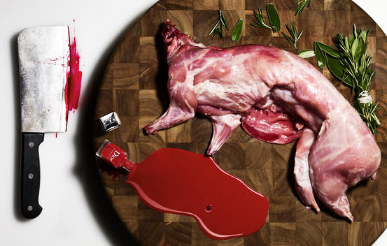 Conceptual still life of Dior Vernis nail color reimagined as the blood of a butchered rabbit.
