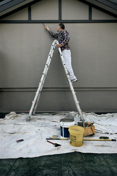Man On Ladder Painting Wall