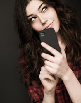 Woman in plaid with phone