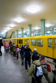 School Children Walking Past A Train Inside A Train Station, Alexander Platz