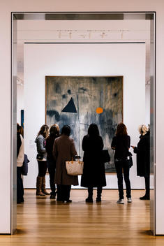 Museum goers look at a painting at the Museum of Modern Art (MoMA).