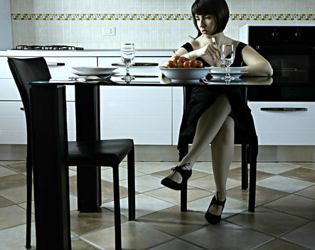 Self-portrait. A girl sitting in front of a lunch table waiting for is lover, that will not come.