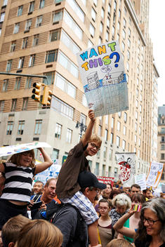 kids holding a banners pro environment at the climate march
