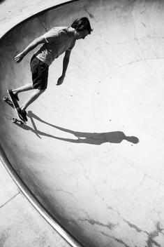 graphic black and white image of 20 something man skateboarding in the Santa Barbara skate park.