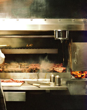 A Chef Cooks Steaks And Other Meats On A Hot Grill.