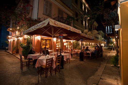 People Enjoying Dinner Outside A Restaurant, Nafplion, Greece.