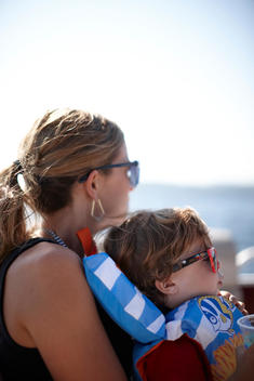 A photo of a mother and her son on a boat
