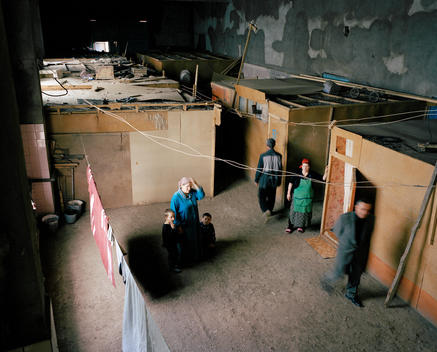 In The Internally Displaced People\'s Settlement 50 Kilometers From The Border With Chechnya, Hadijhat (Wearing Blue Dress) Lives In A Small Wooden House, Inside A Derelict Factory Where Residents Have Built Themselves Temporary Dwellings. She Shares The H