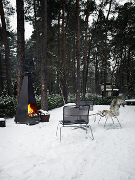 chairs in front of fire outside in snow