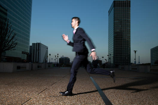 Businessman running in La Defense, Paris