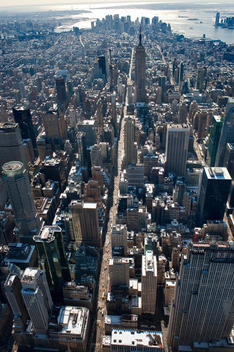 Aerial View Of Manhattan Looking South On Fifth Avenue Toward The Empire State Building On A Bright Day With Surrounding Skyscrapers. New York, New York.