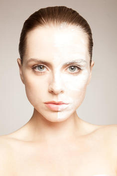 Model with powder on one side of face