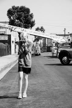 Fashion model Pyper America walking down street with LA fire truck in background.