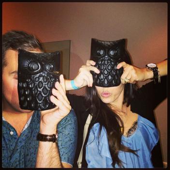 Girl and guy wearing owl masks