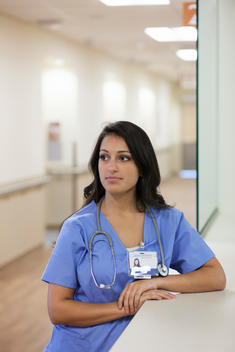 Mixed race nurse standing in hospital corridor
