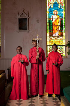 Portrait Of Altar Boys And Girl Of African-American Appearance In Ceremonial Religious Attire