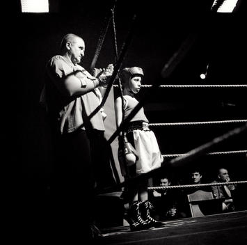 Eleven Year Old Boy And His Corner Man Stand In The Red Corner Waiting For The Bell To Ring For The First Round Of His Amateur Boxing Match.